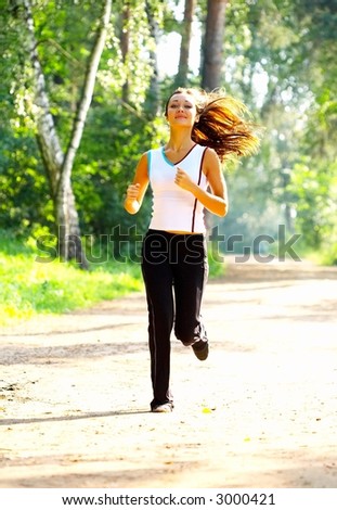 The sports girl runs in park