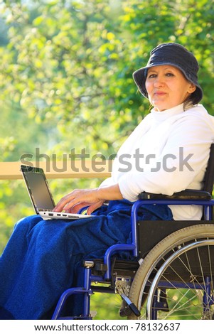 Sitting In Wheelchair Using Laptop