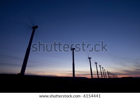 Wind turbines with turning blades at dusk in eastern Washington