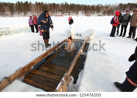Moscow, RUSSIA - JANUARY 19: Swimming in the ice-hole, celebration of Epiphany (Holy Baptism)  in the Orthodox tradition, January 19, 2013 in Moscow, Russia.