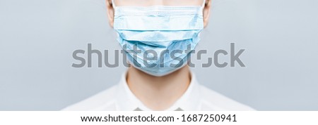 Girl Doctor wearing protection face mask against covid-19. Banner panorama medical staff preventive gear about coronavirus. Woman in medical mask stops covid-2019, vaccine Stock fotó © 