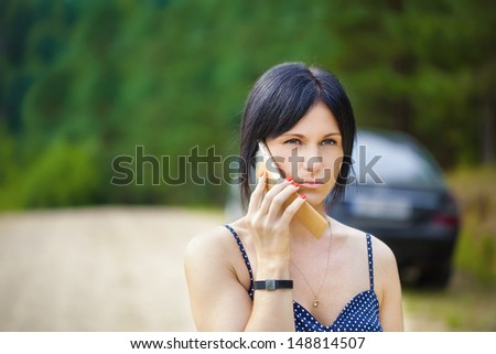 Woman with a cell telephone on the road