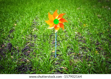 Toy windmill on a field