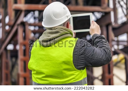 Engineer filmed with tablet PC in factory