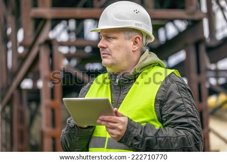 Engineer with tablet PC at factory