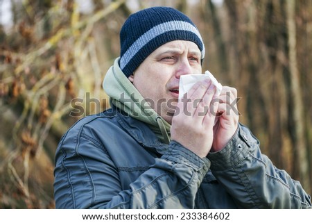 Man with napkin going to sneeze