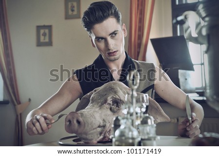 Young handsome fashioned men eat pig