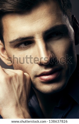 Portrait of handsome young man, sexy guy looking at camera
