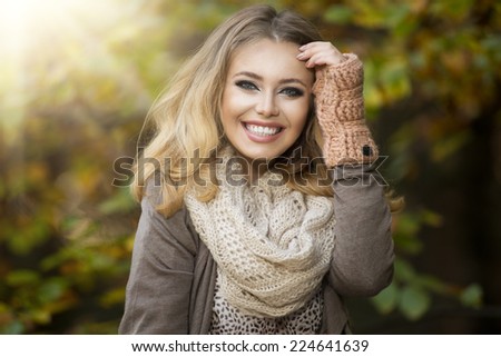 Beautiful elegant woman  in a park in autumn