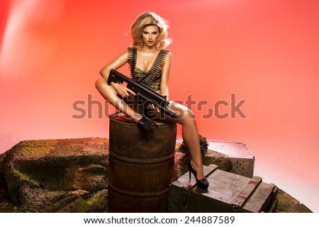 Sexy blonde woman with rifle