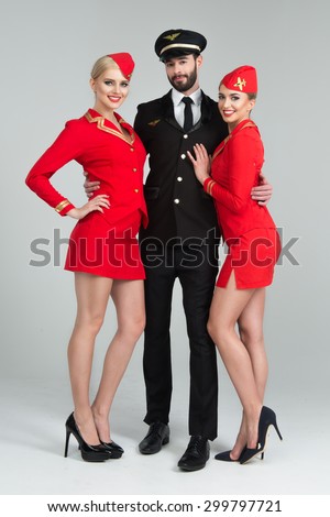Happy group of pilots and stewardesses