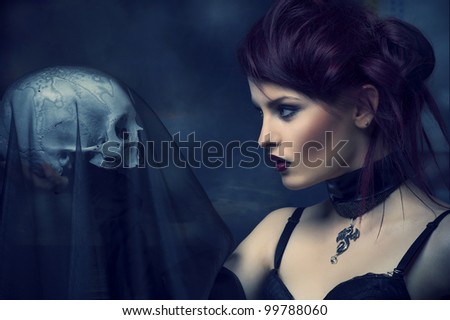 Young alternative woman with a skull.
