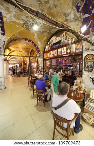 ISTANBUL, TURKEY- MAY 24: Tourists resting in a cafe of Grand bazaar on May 24, 2013. Grand Bazaar is in Fatih district of Istanbul, Turkey. It is Asian style market and attracts visitors.