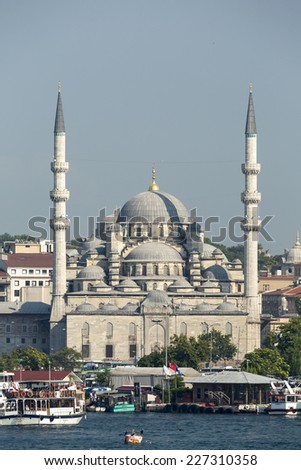 ISTANBUL, TURKEY - October 10, 2014: View of Yenicami Mosque from Golden Horn on October 10, 2014. Yenicami mosque is near Golden Horn in Istanbul, Turkey.