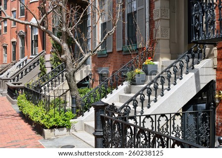 Detail of the charming Boston South End architecture, wrought iron frences and railings, stone steps and trim, red brick walls and sidewalks
