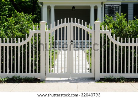 Front gate and picket fence on elegant house entrance
