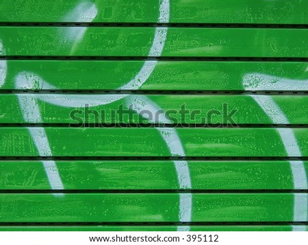 Detail of a green and whithe graffiti close-up with horizontal lines