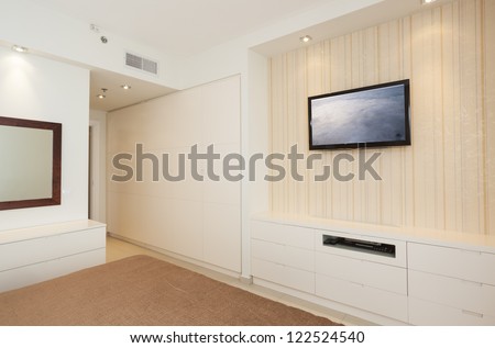 Modern luxury bedroom with wallpaper and LCD television /  Hotel Room