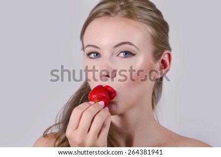Beautiful Model With Strawberry Lips Eating A Strawberry