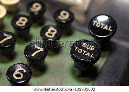 close up of number keys on antique adding machine with focus on sub total