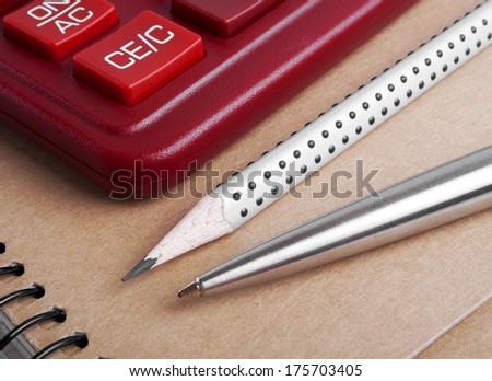 The calculator, pen and pencil, close up