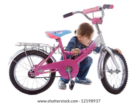 Young caucasian girl repair her bike isolated on white