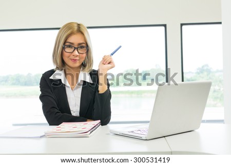 business women smiling and pen in hand
