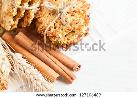 stack grain cookies and cinnamon sticks, closeup