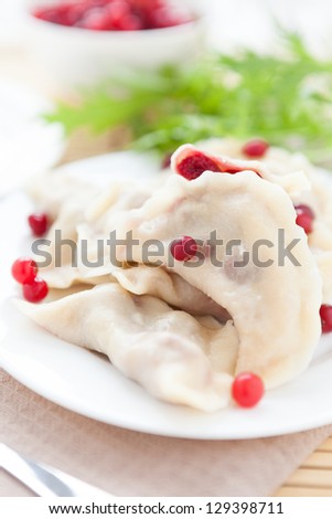 cooked cranberry dumplings on white dish, closeup