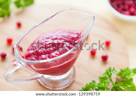 thick flavorful cranberry sauce in a glass gravy boat, food