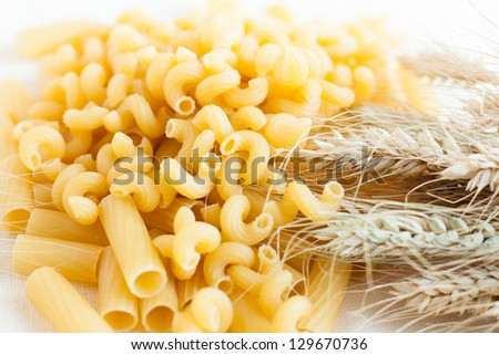 uncooked pasta and wheat ears, raw food
