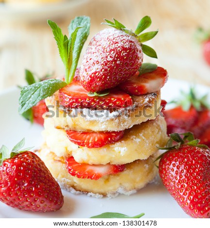 stack of homemade curd pancake with strawberry slices, food closeup