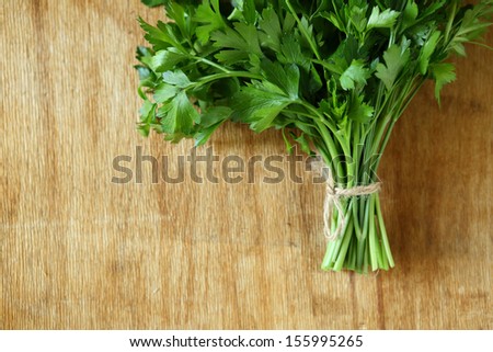 bundle of fresh herbs on a wooden surface, food