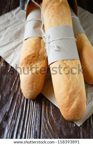 fresh baguettes tied with kraft paper, food close up