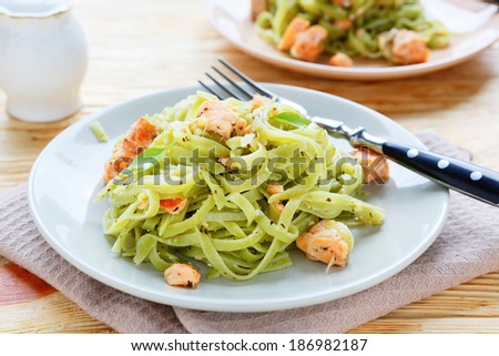 nutritious spinach pasta with salmon, food closeup