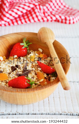granola with strawberries and chocolate chips, food closeup