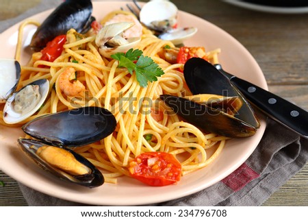 Delicious Italian pasta with squid and mussels in a plate, nutritious food