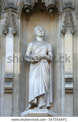 LONDON, UK - JULY 6: Statue of Esther John from facade of Westminster Abbey on July 6, 2013 in London. Westminster Abbey is UNESCO World Heritage Site.