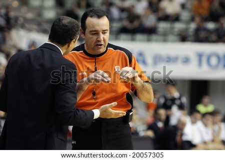 Murcia, Spain - October 19: Manolo Hussein, coach of CB Murcia, talks to the referee during the game against Vive Menorca at Palacio de los Deportes on October 19, 2008 in Murcia, Spain
