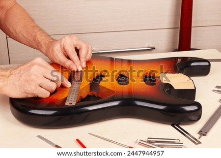 Similar – Image, Stock Photo Craftsman tuning string instrument in workshop