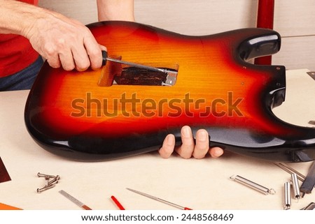Similar – Image, Stock Photo Craftsman tuning string instrument in workshop