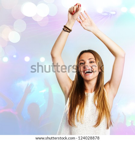 Young attractive woman dancing to the beat with disco background.