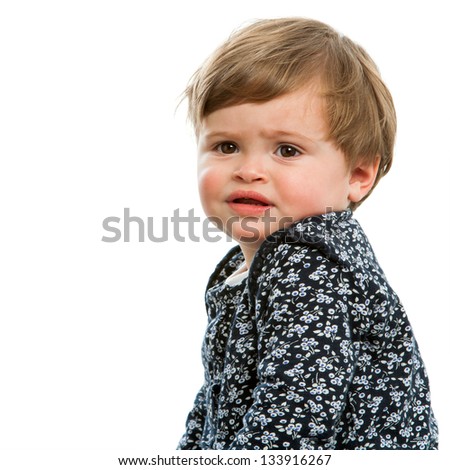 Close up portrait of toddler with confused face expression.Isolated.