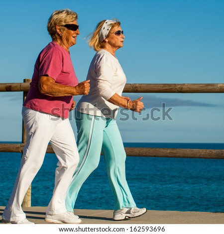 Action portrait of golden age women having early morning jog.