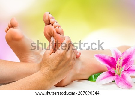 Extreme close up of female Spa therapist doing foot massage.