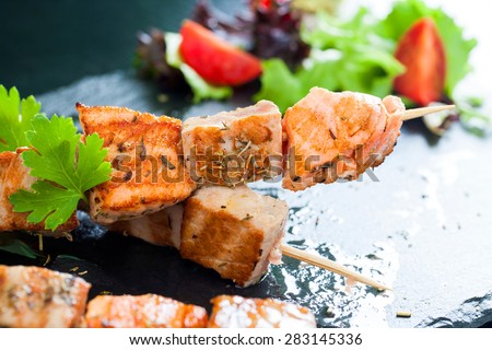 Macro close up of fresh tuna and salmon brochettes grilled.