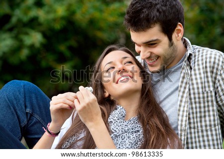 Close up portrait of attractive young  couple in love outdoors.