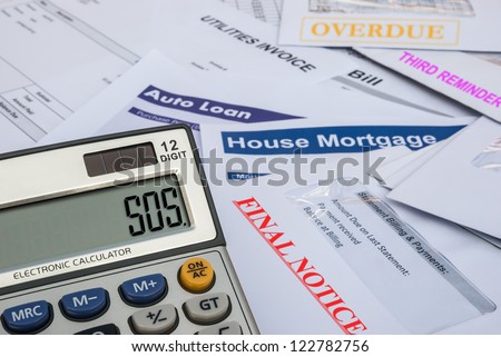 different invoices and bills and a calculator shows SOS, finacial concept