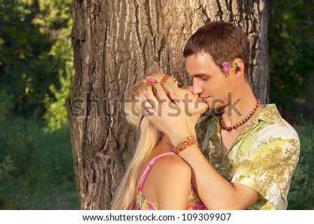 young man kisses fine young woman. style of hippie