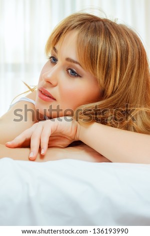 blond woman think in bed